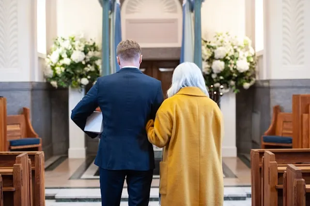 a family carrying an urn